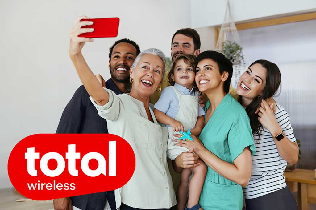Cheerful family taking selfie with smart phone in kitchen